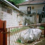 Almasa A. (2000)  - My house used to be a happy one, but now it seems so sad to me without my family. (At the time the photo was taken Almasa was not even allowed to enter the garden. There were refugees living there. Since the spring of 2001 it has become her house again).

