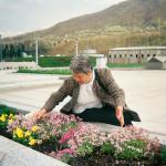 Almasa A. (2005)  - At the memorial in Potočari. At this moment my heart feels heavy, because my husband and my son are not here. Flowers instead of (the grave) a child.