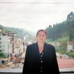 Timka S. (2000)  - It is a joyful experience to be allowed to be photographed on the balcony of my house in Srebrenica after five years. (Serb refugees live there now).